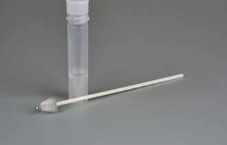 Bildet viser en børste og et prøveglass.