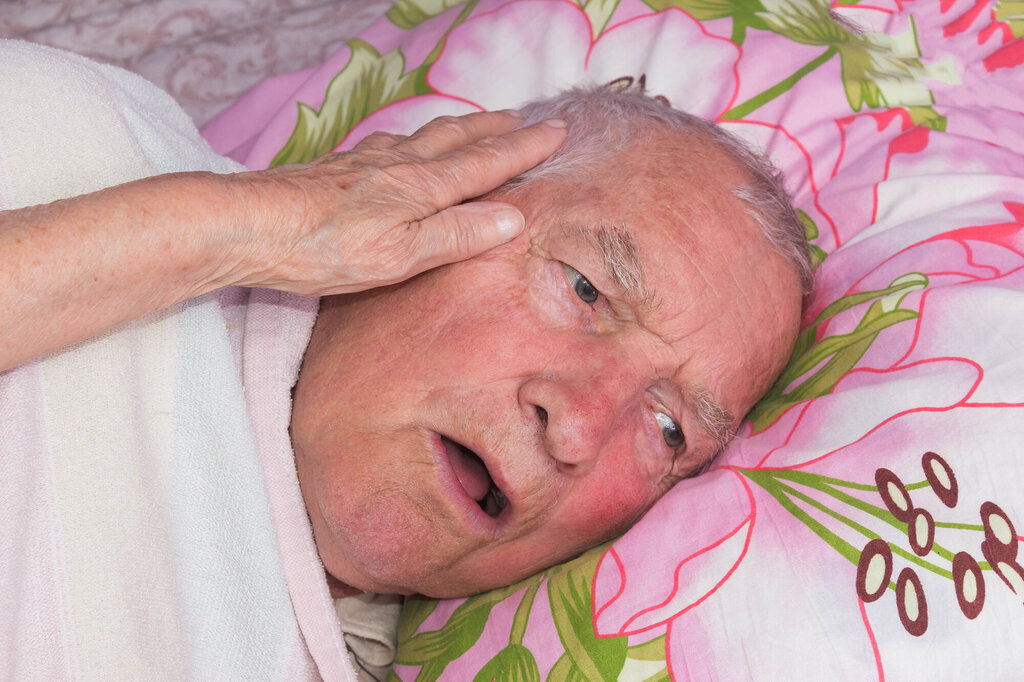 Bildet viser syk eldre mann i seng