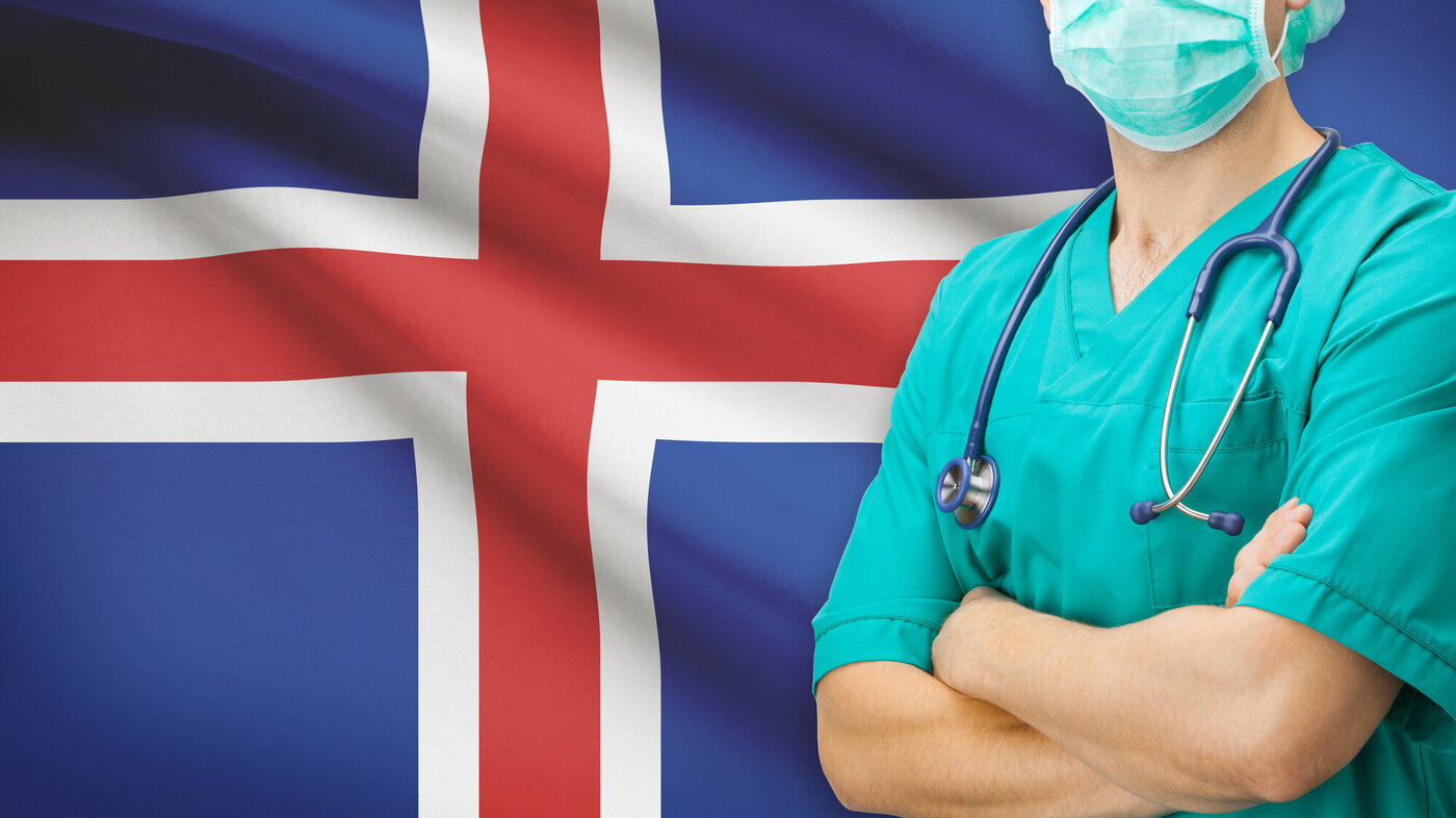 Bildet viser helsepersonell foran islandsk flagg.