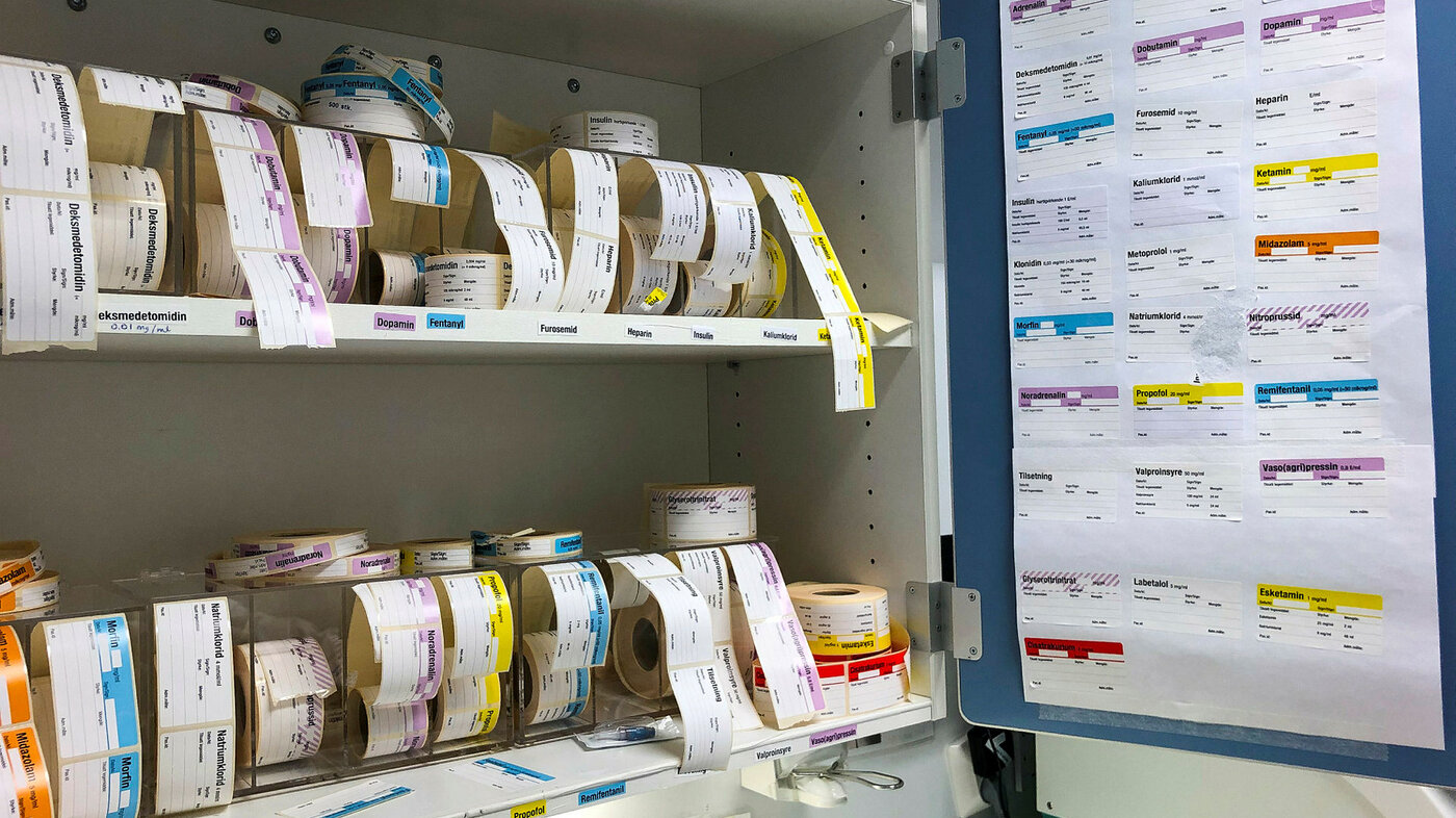 Bildet viser et skap med ferdig trykte merkelapper til å sette på utblandete medisiner.